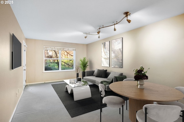 carpeted living room featuring track lighting