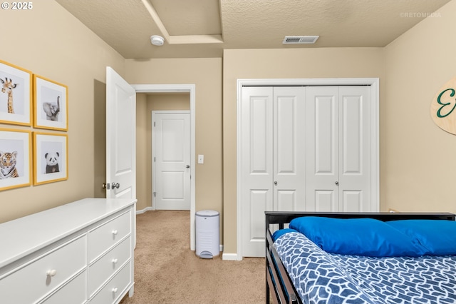 21889 SW Cedar Brook Way, Sherwood, OR 97140 - bedroom with light colored carpet, a closet, a textured ceiling, and attic access