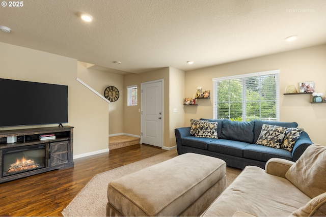 21889 SW Cedar Brook Way, Sherwood, OR 97140 - living area with wood finished floors, plenty of natural light, recessed lighting, a glass covered fireplace, and a textured ceiling