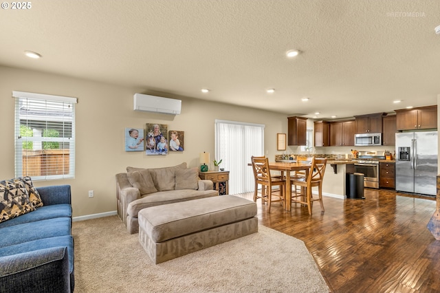 21889 SW Cedar Brook Way, Sherwood, OR 97140 - living area featuring a wall mounted air conditioner, recessed lighting, a textured ceiling, and dark wood-type flooring