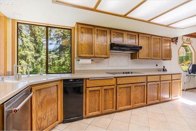 16649 S Holcomb Blvd, Oregon City, OR 97045 - kitchen featuring dishwasher, black electric cooktop, brown cabinets, under cabinet range hood, and light countertops
