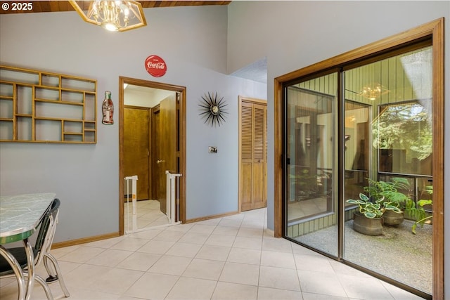 16649 S Holcomb Blvd, Oregon City, OR 97045 - dining room with baseboards, a chandelier, light tile patterned floors, and high vaulted ceiling