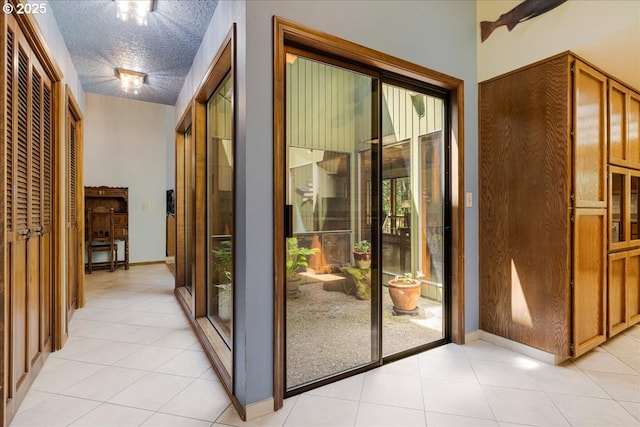 16649 S Holcomb Blvd, Oregon City, OR 97045 - doorway featuring light tile patterned floors, a textured ceiling, and baseboards