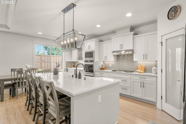 7705 NE 181st Ct, Vancouver, WA 98682 - kitchen with stainless steel appliances, light countertops, decorative backsplash, white cabinetry, and a sink