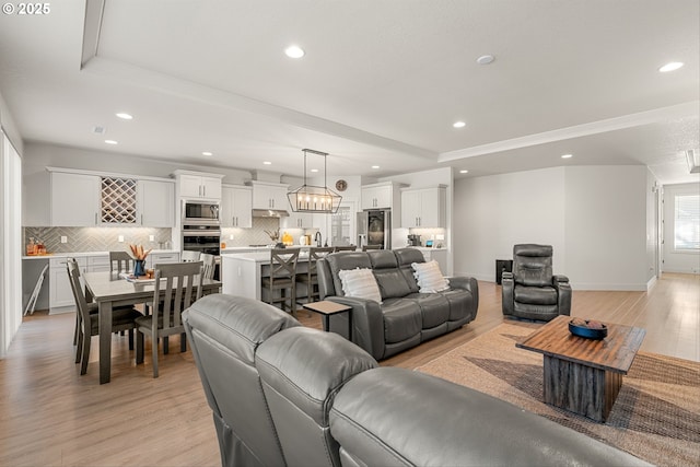 7705 NE 181st Ct, Vancouver, WA 98682 - living area with recessed lighting, light wood-type flooring, a raised ceiling, and baseboards