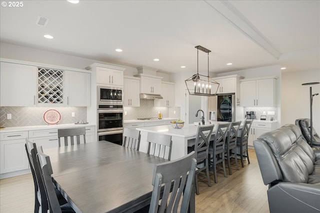 dining room with visible vents, light wood-type flooring, and recessed lighting
