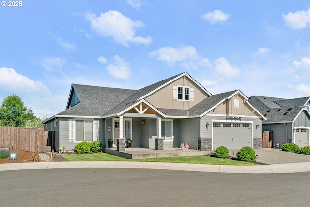 7705 NE 181st Ct, Vancouver, WA 98682 - craftsman house featuring a porch, board and batten siding, a garage, driveway, and stone siding