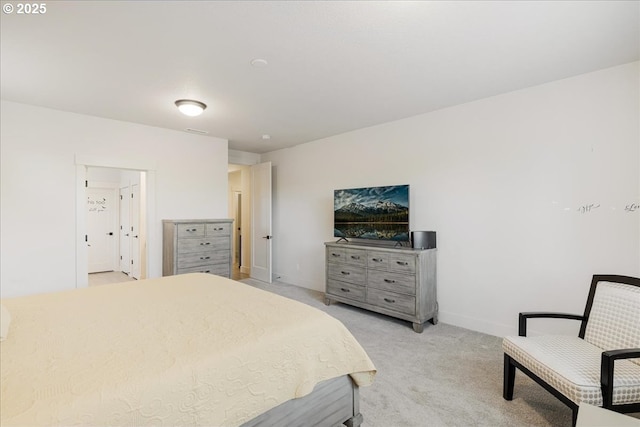 bedroom with light carpet and baseboards