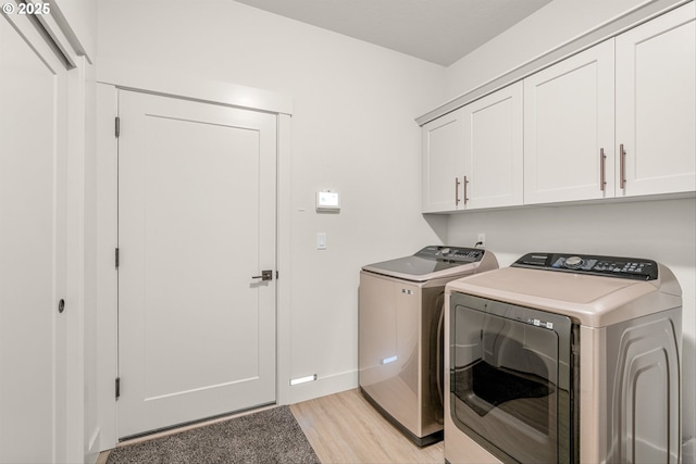 7705 NE 181st Ct, Vancouver, WA 98682 - washroom with independent washer and dryer, cabinet space, light wood-type flooring, and baseboards