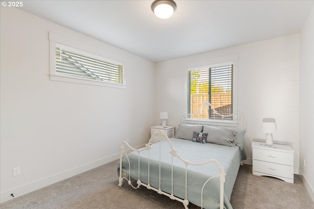 carpeted bedroom featuring baseboards