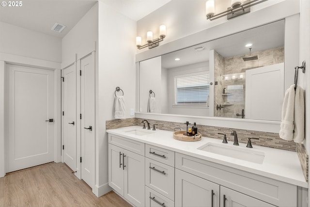 7705 NE 181st Ct, Vancouver, WA 98682 - bathroom with a shower stall, backsplash, double vanity, and wood finished floors