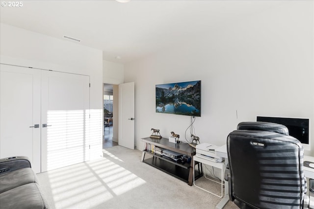 carpeted living area featuring visible vents