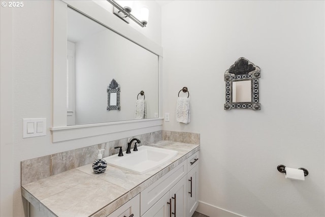 bathroom with baseboards and vanity
