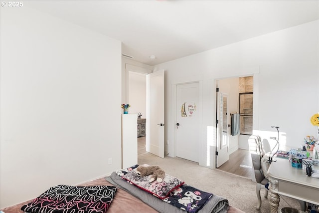 bedroom featuring light colored carpet