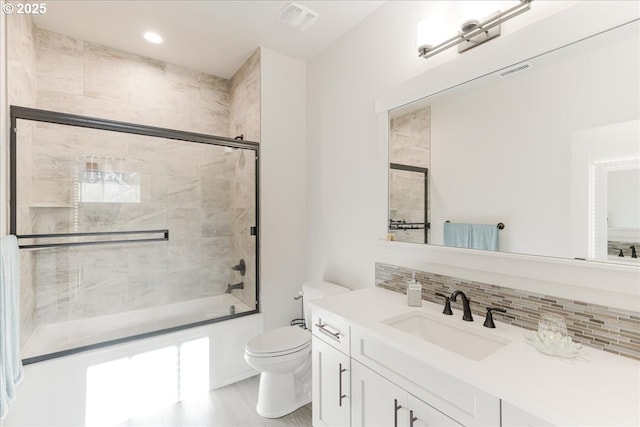 full bath featuring bath / shower combo with glass door, visible vents, tasteful backsplash, and toilet