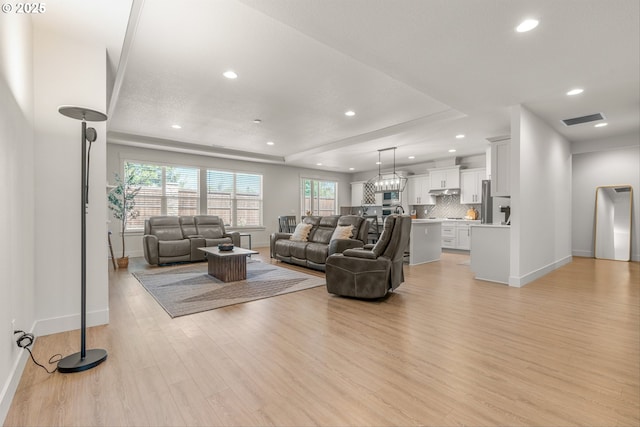 7705 NE 181st Ct, Vancouver, WA 98682 - living room with light wood-style flooring, baseboards, recessed lighting, and a tray ceiling