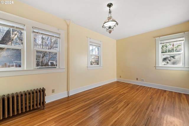 1706 Oak St, La Grande, OR 97850 - spare room with radiator, wood finished floors, and baseboards