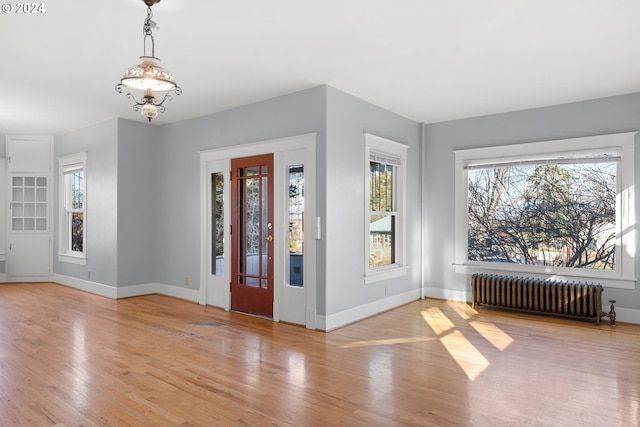 1706 Oak St, La Grande, OR 97850 - entryway featuring radiator, plenty of natural light, wood finished floors, and baseboards