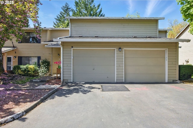 view of front of home featuring a garage and asphalt driveway