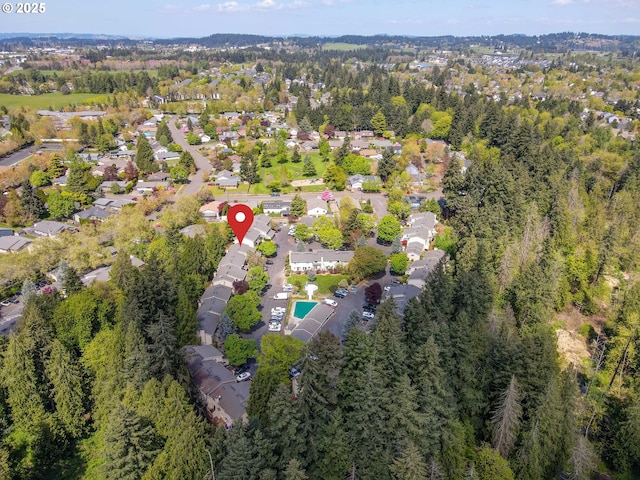 aerial overview of property's location featuring nearby suburban area and a pool