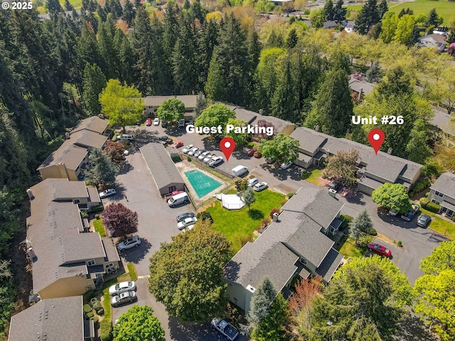 aerial view of property and surrounding area with nearby suburban area and a pool