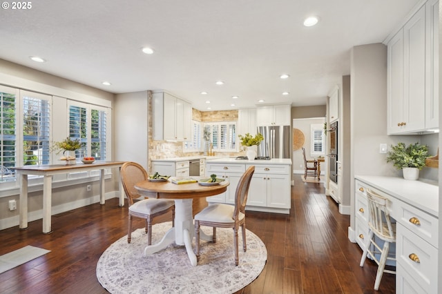 dining room featuring dark wood-style floors, baseboards, and recessed lighting