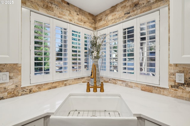 details with light countertops, a sink, and white cabinetry