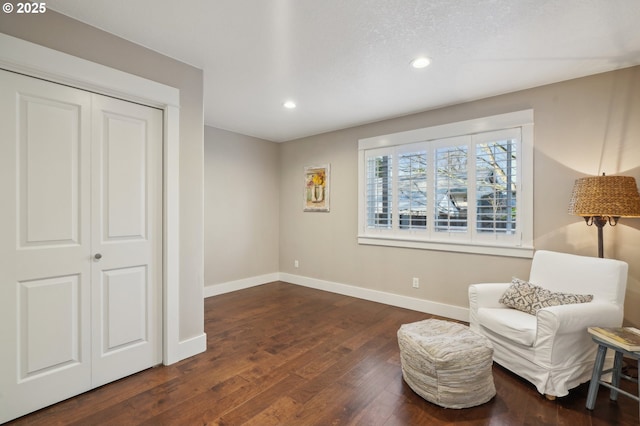 living area with baseboards, hardwood / wood-style floors, and recessed lighting