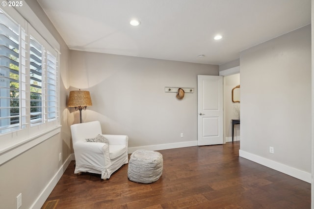 sitting room with baseboards, wood finished floors, and recessed lighting