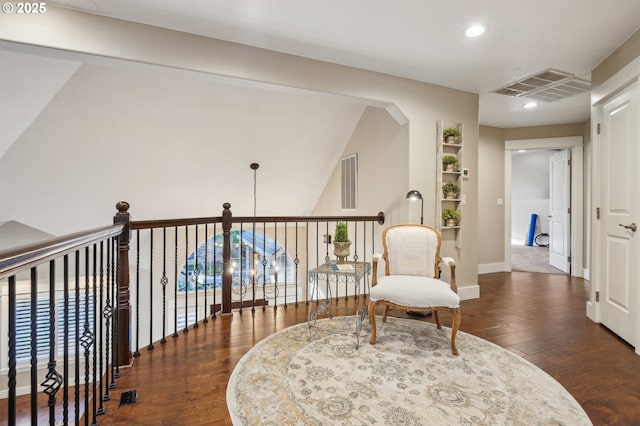 sitting room with baseboards, visible vents, dark wood finished floors, and recessed lighting