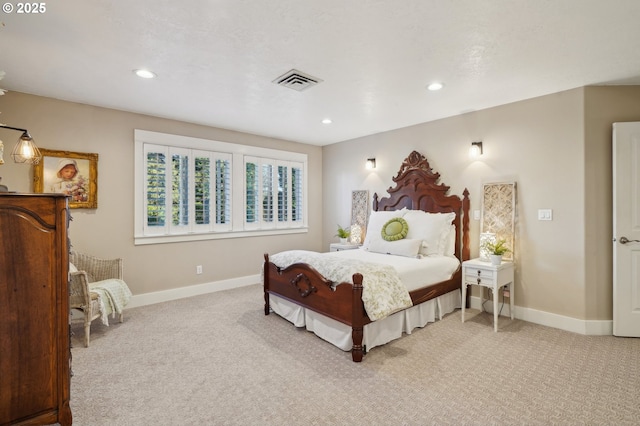 carpeted bedroom featuring recessed lighting, visible vents, and baseboards