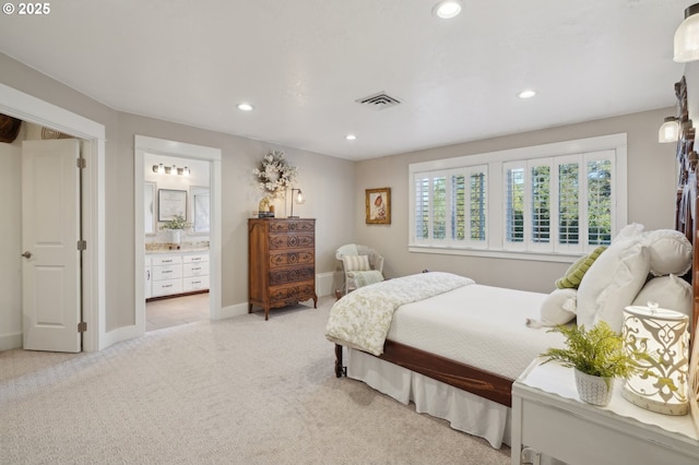 bedroom with recessed lighting, visible vents, light carpet, connected bathroom, and baseboards