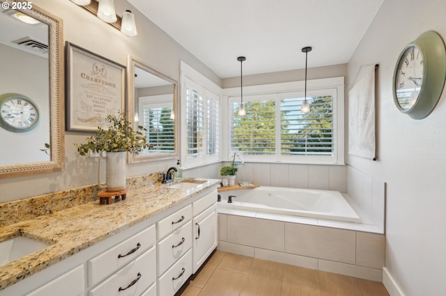 full bathroom featuring a garden tub, double vanity, a sink, and visible vents