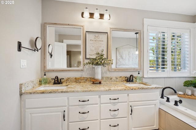 full bathroom featuring double vanity, a sink, and a bathing tub