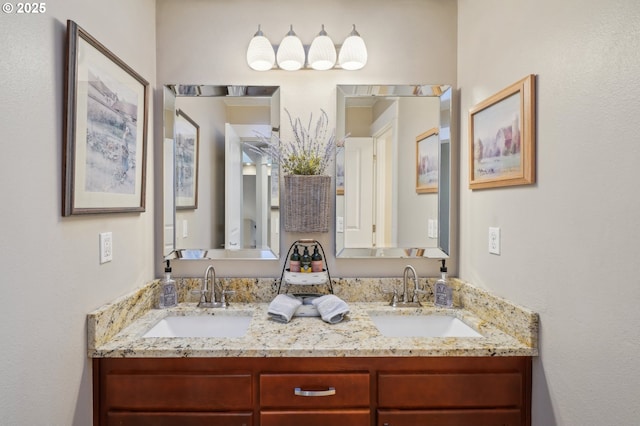 bathroom featuring a sink and double vanity