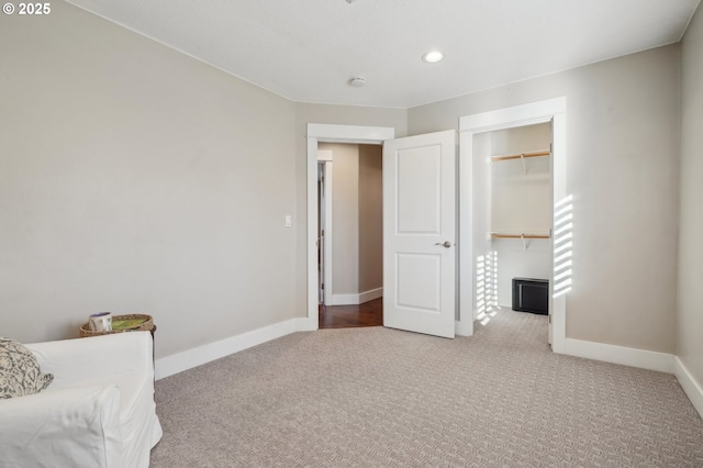 carpeted bedroom featuring recessed lighting, a closet, a spacious closet, and baseboards