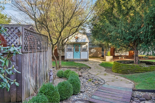 view of yard featuring an outdoor structure and fence