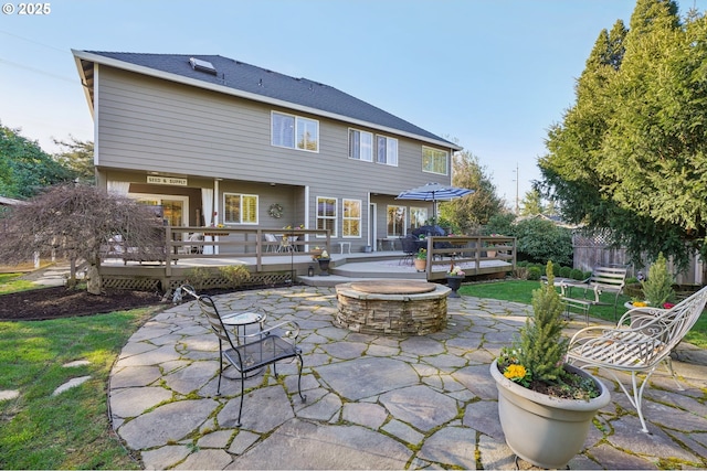 back of house featuring a patio area, an outdoor fire pit, and a wooden deck