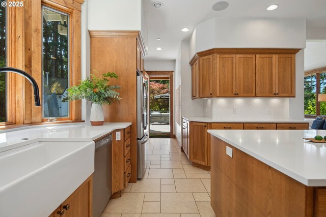 20754 SW Prindle Rd, Tualatin, OR 97062 - kitchen with a sink, brown cabinetry, stainless steel appliances, light countertops, and recessed lighting