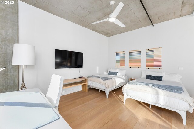 bedroom with ceiling fan and light hardwood / wood-style flooring