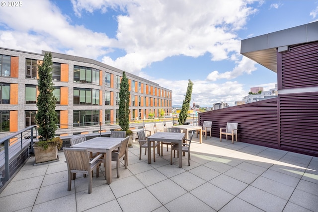 view of patio / terrace featuring a view of city and outdoor dining space