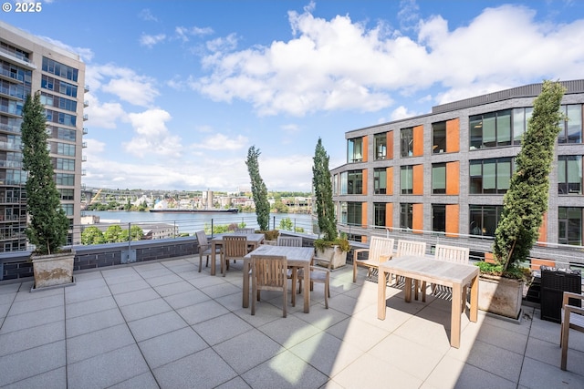 view of patio / terrace with outdoor dining area and a water view