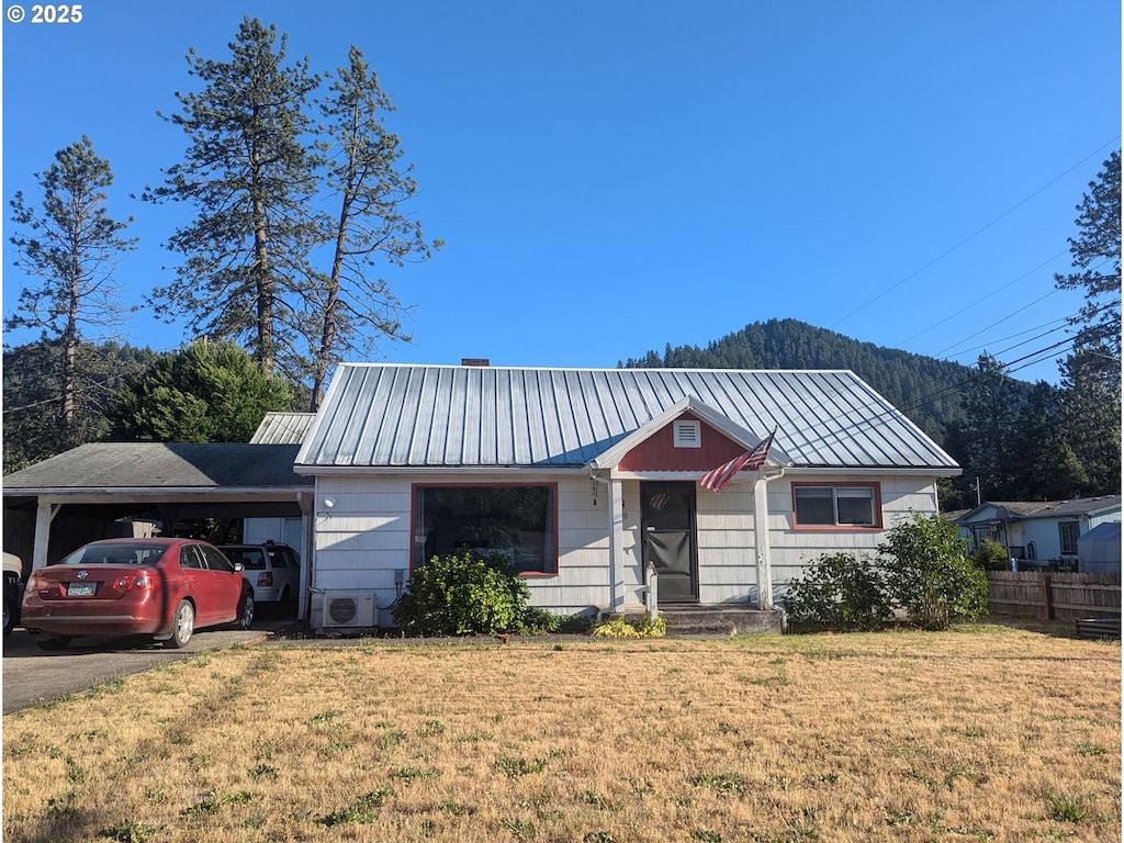 47564 School St, Oakridge, OR 97463 - view of front of house with a metal roof, a carport, and asphalt driveway