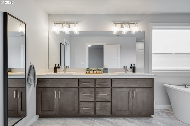 2511 S White Salmon Dr, Ridgefield, WA 98642 - full bathroom with marble look tile flooring, double vanity, and a freestanding bath
