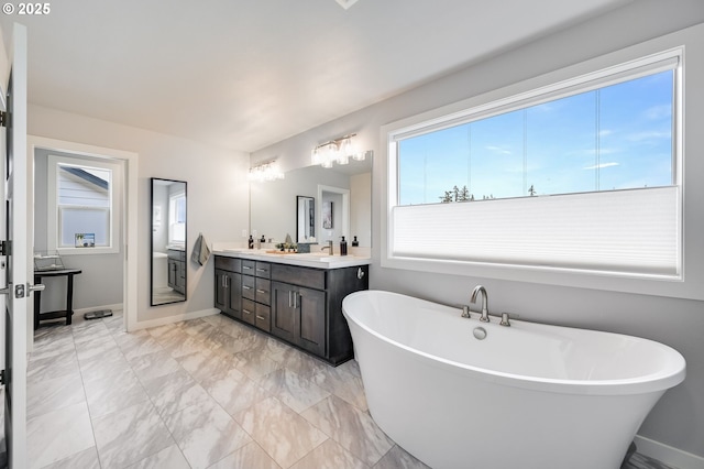2511 S White Salmon Dr, Ridgefield, WA 98642 - bathroom with a freestanding bath, double vanity, and marble finish flooring