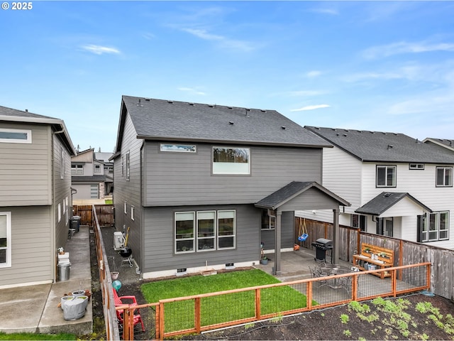 2511 S White Salmon Dr, Ridgefield, WA 98642 - back of property with a patio area, a fenced backyard, a shingled roof, and a residential view