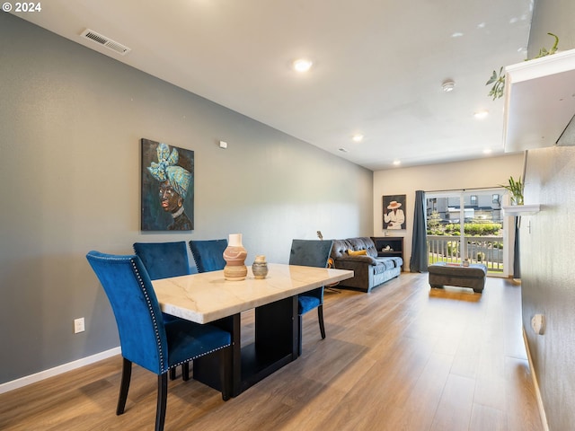 dining room featuring recessed lighting, wood finished floors, visible vents, and baseboards