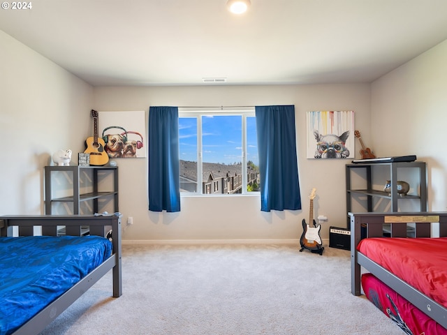 bedroom featuring carpet floors, visible vents, and baseboards