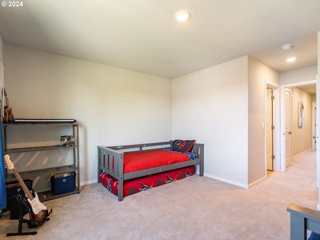 carpeted bedroom featuring baseboards and recessed lighting