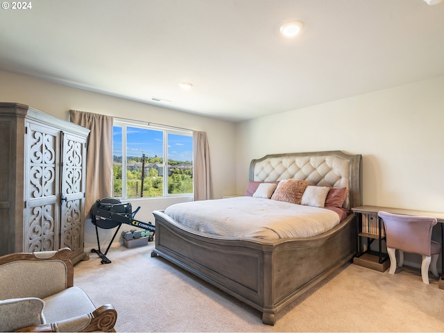 bedroom with light carpet, visible vents, and baseboards